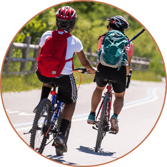 Two cyclists riding on a path