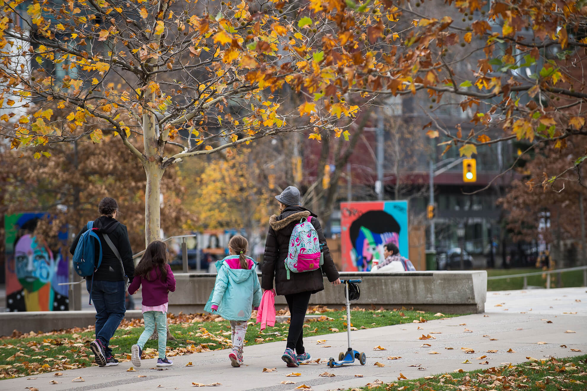 6 Acre Park - two mothers walking with their daughters and a scooter